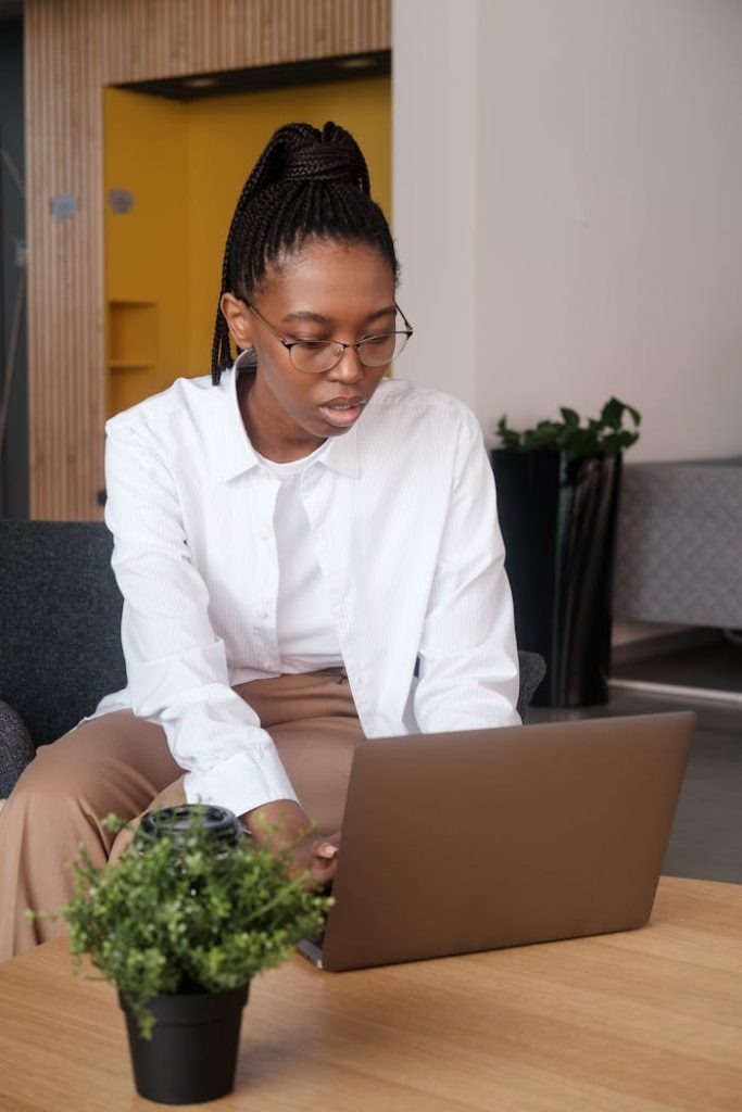Black female employee browsing laptop
